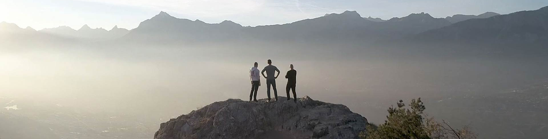 Three people, one with a B-Chill CBD sweatshirt, admiring the beautiful mountains of the Valais